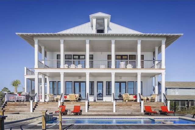 A white beach house with a pool